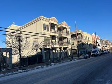 Atlantic Highlands apartment for rent - A row of buildings with a car parked on the street.