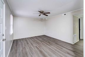 Winston-Salem apartment for rent - A room with a ceiling fan and light fixture.