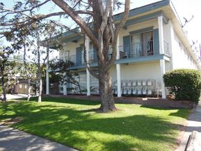 Westminster apartment for rent - A tree in front of a white house with a balcony.