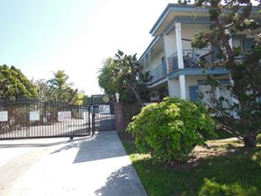 Westminster apartment for rent - A gated entrance to a building with a sign on the gate.