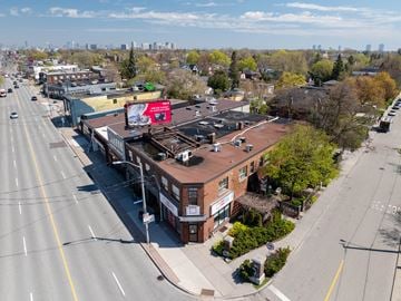 Toronto apartment for rent - A city street with a red billboard on a building.