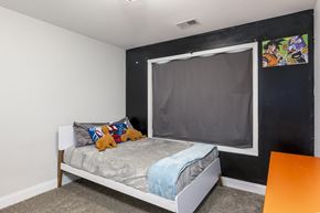 Clarksville house for rent - A bedroom with a bed, pillows, and a window with a blackout cover.