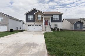 Clarksville house for rent - A house with a red door is in the center of the image.