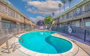 San Jose apartment for rent - A swimming pool in a residential area surrounded by a fence.