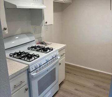 Buena Park apartment for rent - A white gas stove with a white oven in a kitchen.