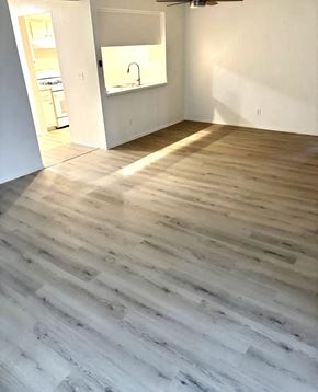 Buena Park apartment for rent - A room with a wooden floor and a mirror on the wall.