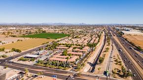 Phoenix apartment for rent - A highway interchange with buildings and green fields in the foreground.
