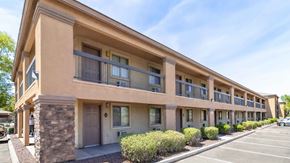 Tolleson apartment for rent - A row of apartment buildings with balconies and doors.
