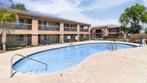 Tolleson apartment for rent - A large swimming pool in front of apartment buildings.
