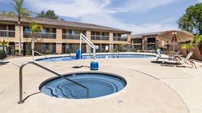 Tolleson apartment for rent - A swimming pool with a diving board and a sun lounger.
