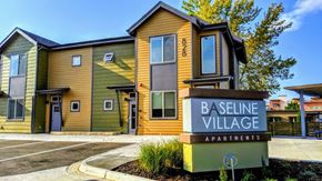 Lafayette apartment for rent - Baseline Village Apartments is a modern apartment complex with a mix of green and yellow exterior colors.