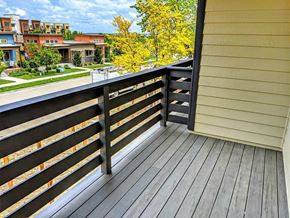 Lafayette apartment for rent - A wooden deck with a railing overlooking a residential area.