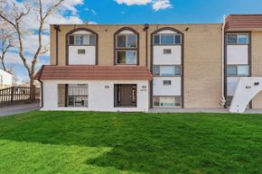 Lakewood apartment for rent - A building with a red roof and white walls with windows.