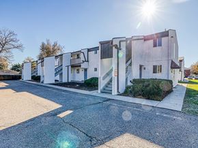 Lakewood apartment for rent - A white building with a green lawn in front.