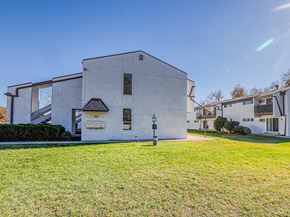 Lakewood apartment for rent - A white building with a black roof and a sign that reads "1289".