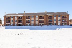 Craig apartment for rent - A large building with a lot of windows and balconies covered in snow.