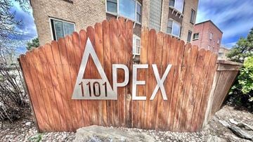 Denver apartment for rent - A building with a red brick border in front of it.