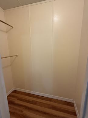 Interlachen house for rent - A white closet with a wooden shelf and a wooden floor.