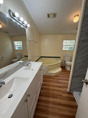 Palatka house for rent - A bathroom with a white tub and sink.