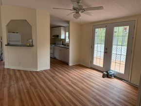 Palatka house for rent - A room with a ceiling fan and wooden flooring.