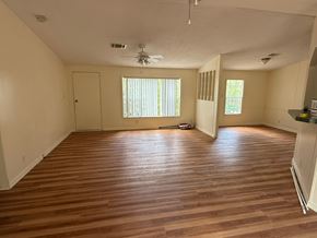 Palatka house for rent - A room with wooden flooring and a ceiling fan.