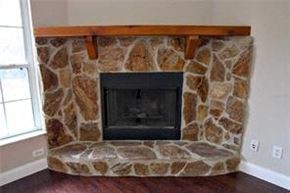 Weirsdale house for rent - A stone fireplace with a wood mantle.