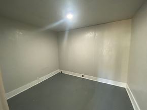 Mobile house for rent - A room with a light on the ceiling and a wall on the left side.