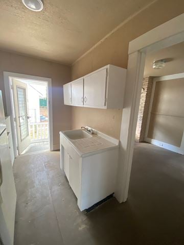Mobile house for rent - A kitchen with white cabinets and a sink.
