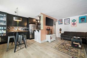 Calgary apartment for rent - A kitchen with a refrigerator, a table, and a couch.