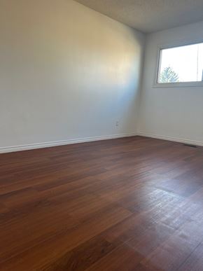 Edmonton house for rent - A room with wooden flooring and a window.