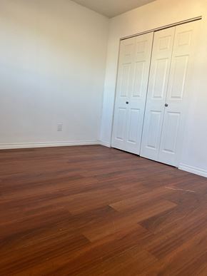 Edmonton house for rent - A room with a white wall and a brown floor.