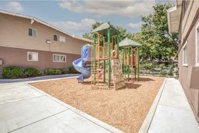 San Jose apartment for rent - A playground with a blue slide and a green roof.