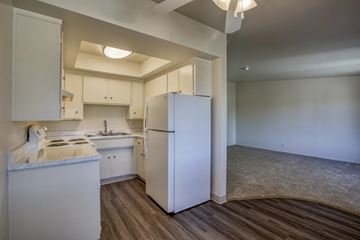 San Jose apartment for rent - A kitchen with white appliances and cabinets.