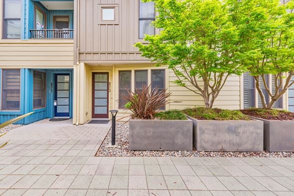 Palo Alto house for rent - A building with a blue door and a tree in front.