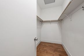 Palo Alto house for rent - A white room with a wooden floor and a door on the left.