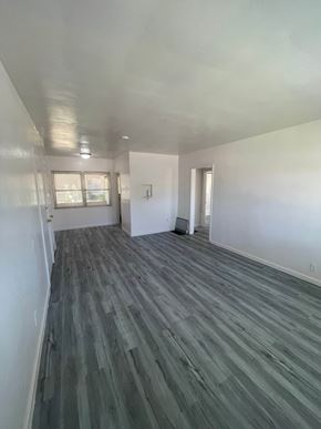 Riverside apartment for rent - A room with a grey floor and white walls.
