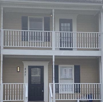 Birmingham house for rent - A two story house with a black door and white railings.