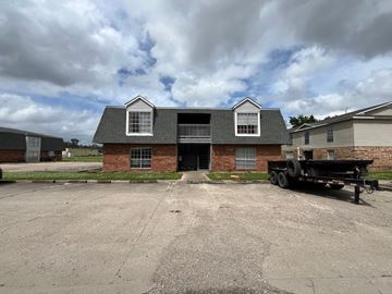 Thibodaux apartment for rent - A black truck is parked in front of a brick house.
