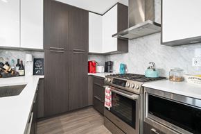 Calgary apartment for rent - A modern kitchen with dark wood cabinets and stainless steel appliances.