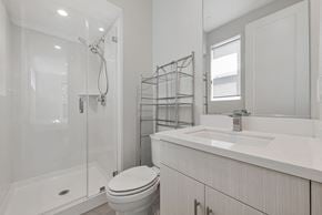 Santa Clara house for rent - A white bathroom with a toilet, sink, and shower.