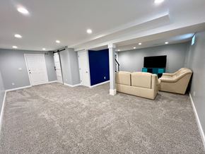 Prospect house for rent - A spacious room with a carpeted floor and a blue door.