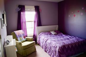 Prospect house for rent - A bedroom with a purple bed and a chair.