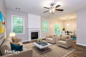 Gainesville house for rent - A living room with a fireplace and a painting on the wall.