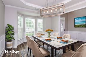 Gainesville house for rent - A dining room with a table set for six and a view of the ocean.
