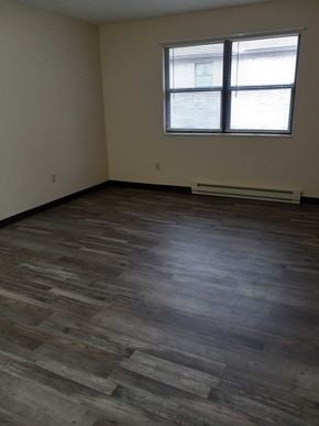 East Liverpool apartment for rent - A room with a window and wooden flooring.