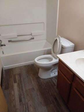 East Liverpool apartment for rent - A white toilet sits in a bathroom next to a sink.