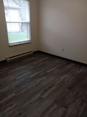 East Liverpool apartment for rent - A room with a window and a wooden floor.