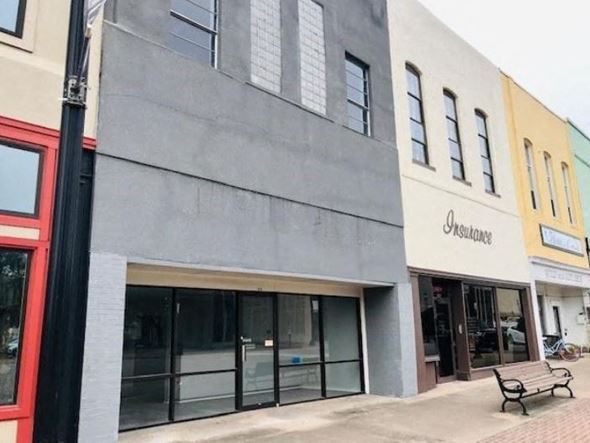 Denison apartment for rent - A grey building with a black pole in front of it.