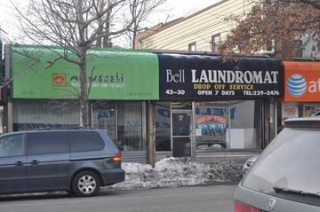 Bayside apartment for rent - A laundromat and an Arabic restaurant share a street corner.