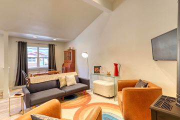 Pagosa Springs apartment for rent - A living room with a grey couch and a brown armchair.